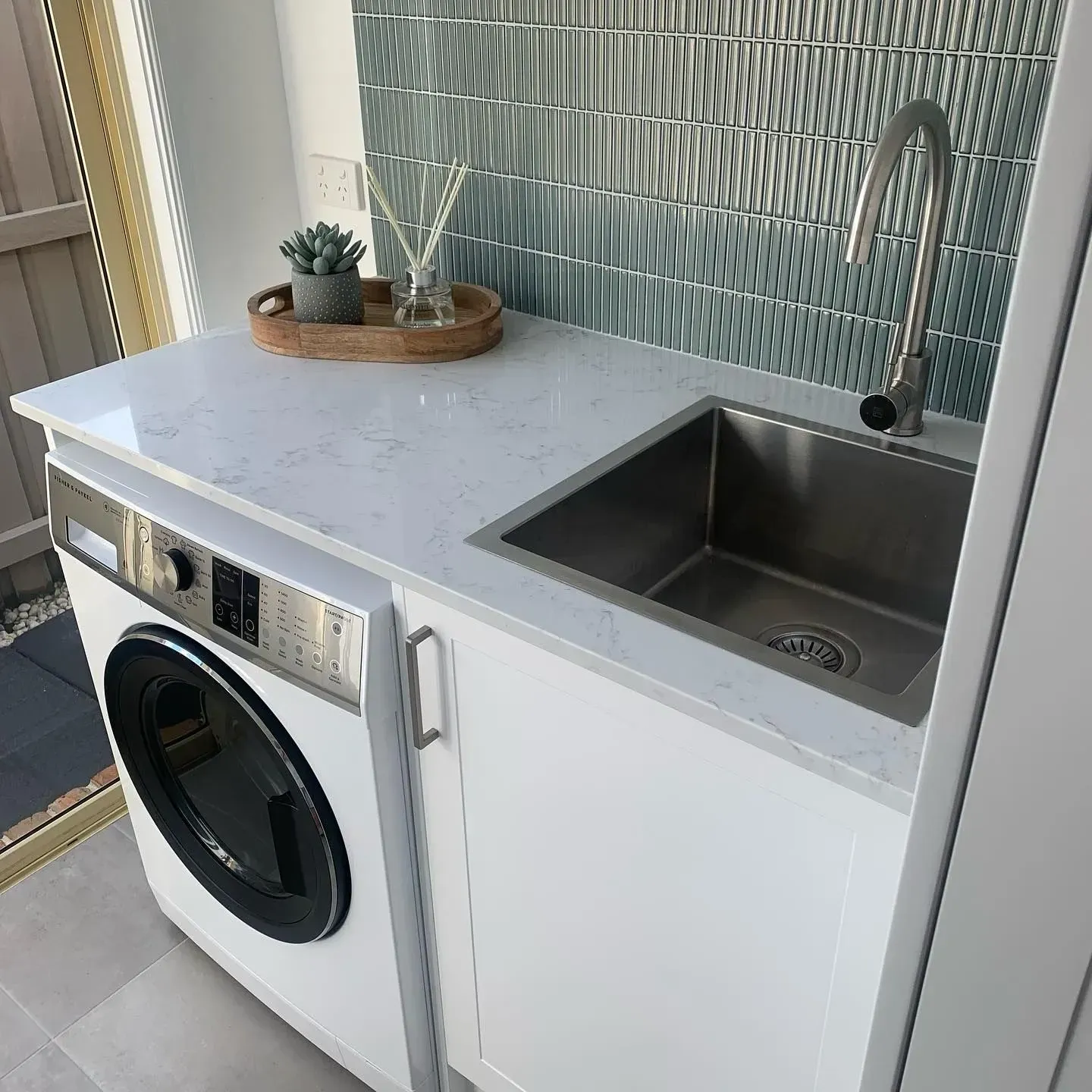 Laundry Room With a Washing Machine, Sink, and a Decorative Backsplash — The Kitchen Centre In Tuggerah, NSW