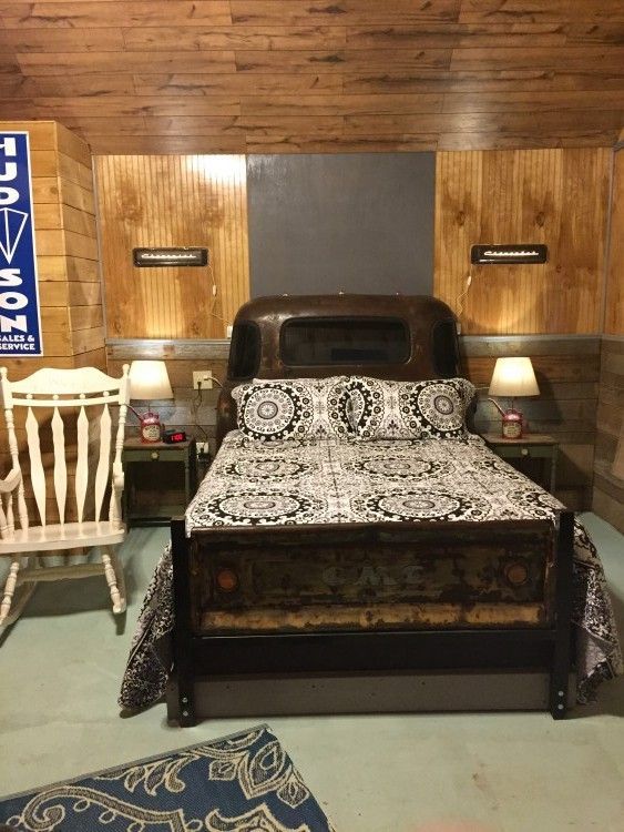 A bedroom with a bed and a sign that says budweiser