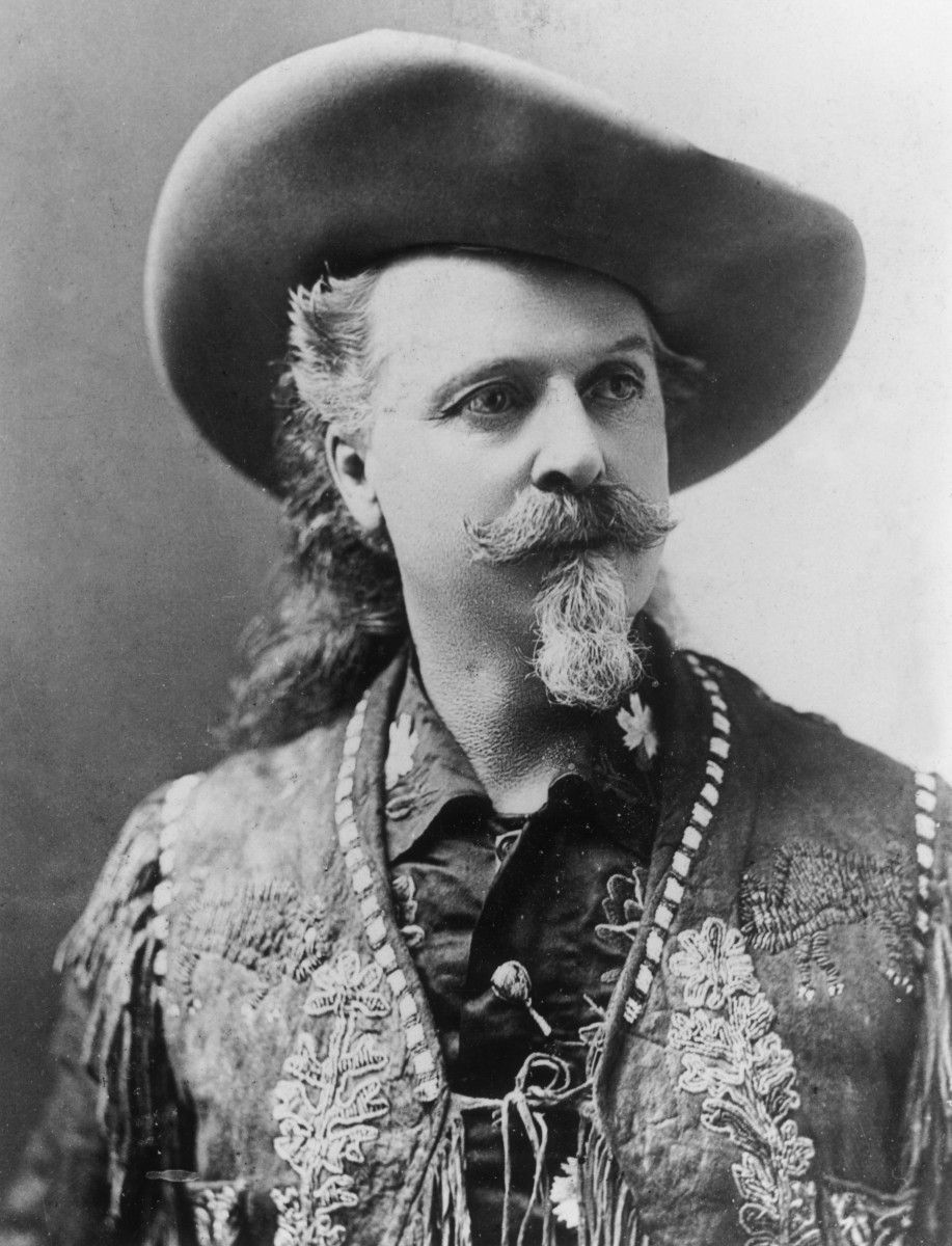 A black and white photo of a man wearing a cowboy hat