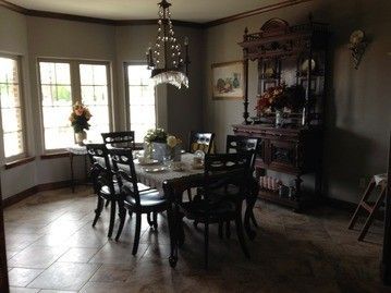 A dining room with a table and chairs and a hutch.