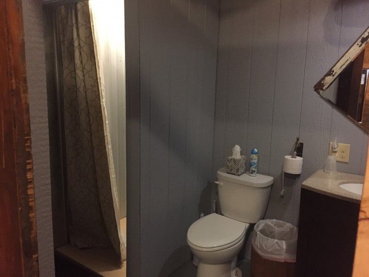 A bathroom with a toilet , sink , and shower.