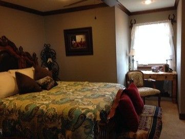 A bedroom with a large bed and a window