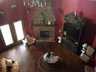An aerial view of a living room with red walls and a fireplace.