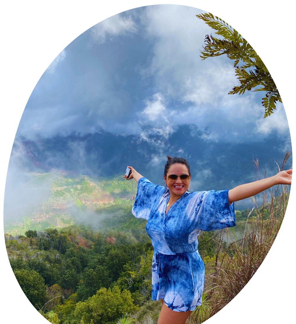 A woman is sitting at a table using a laptop computer.