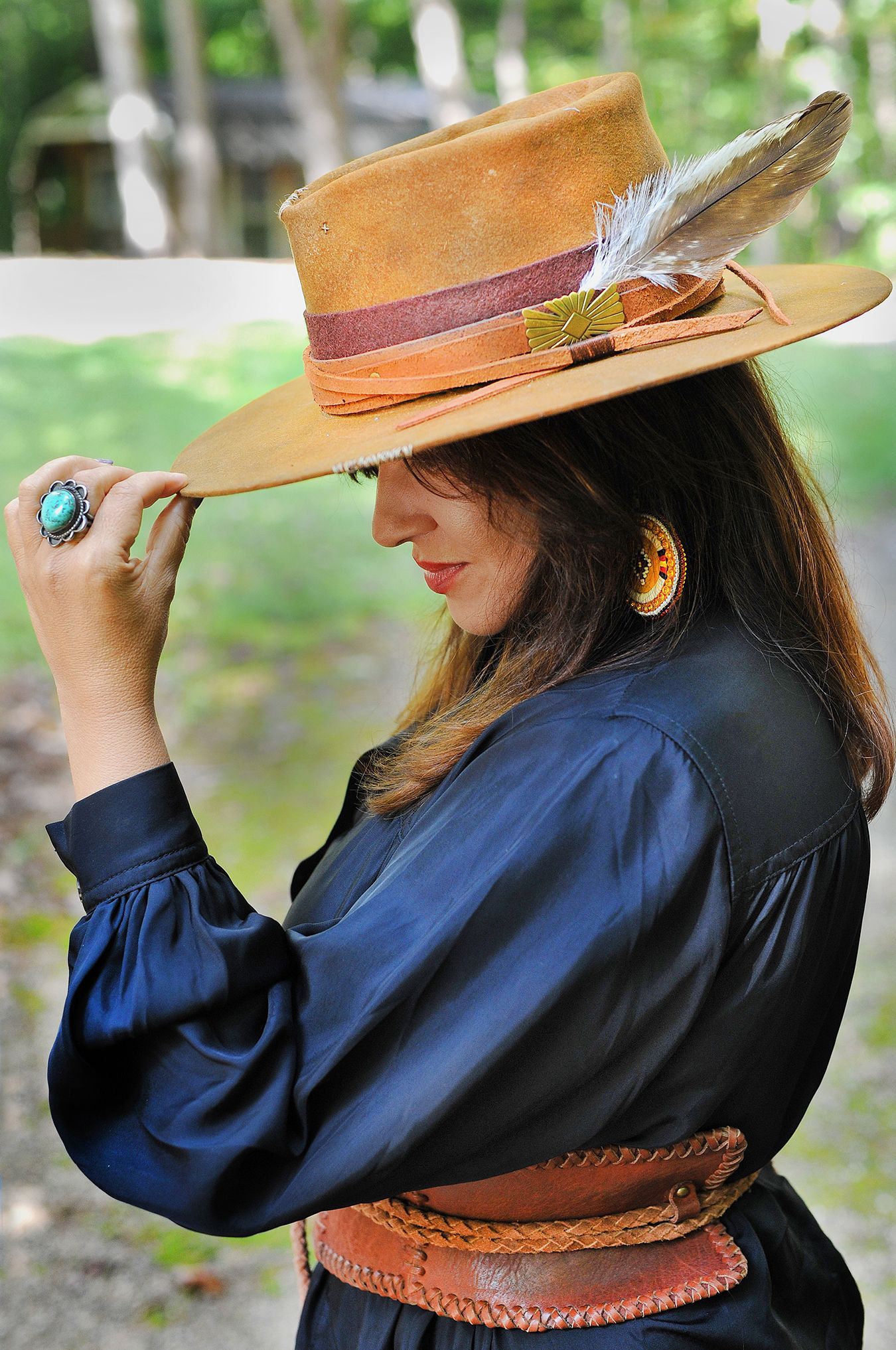 A woman is sitting at a table using a laptop computer.