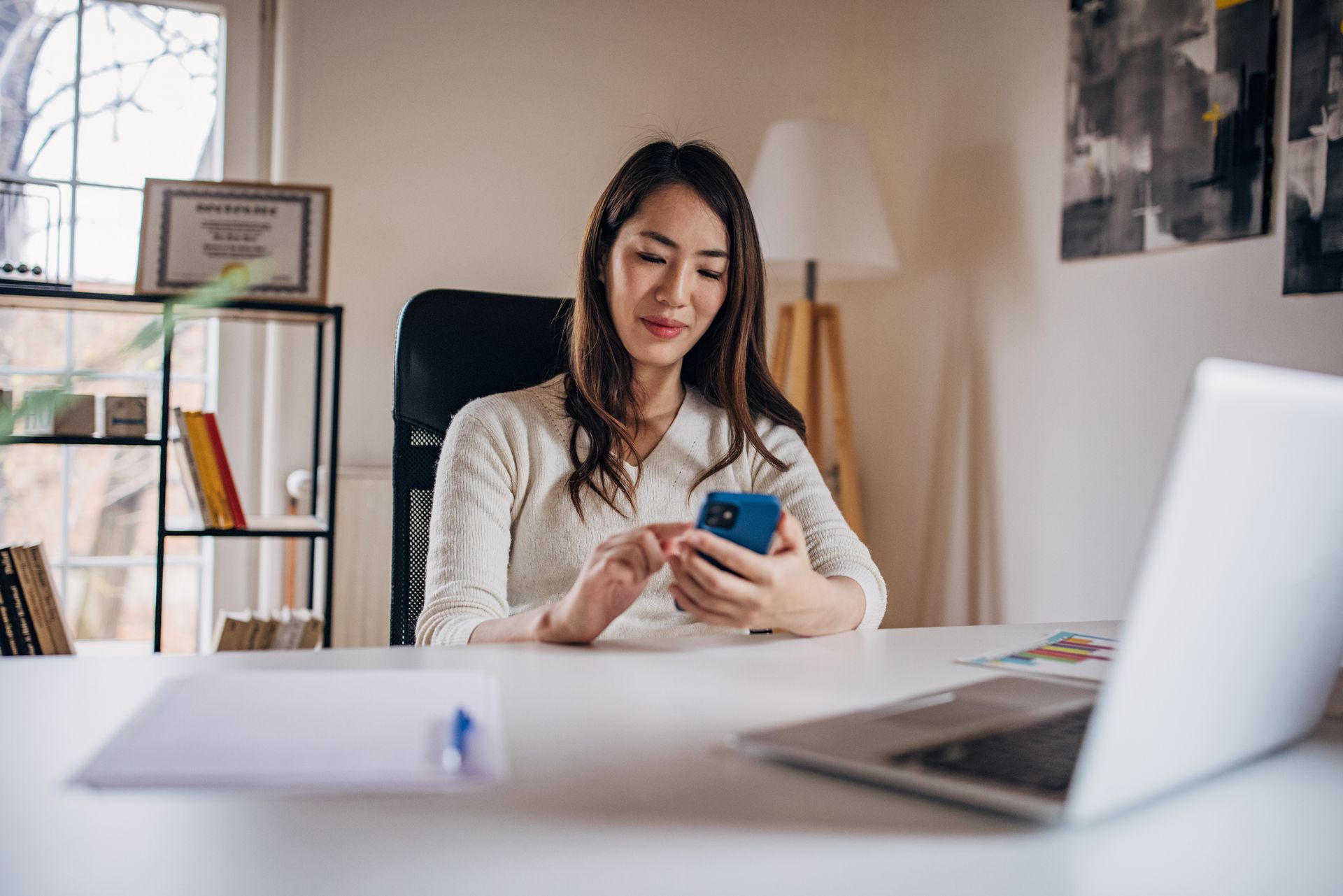 A doctor in a white coat consoles an older patient near a window.