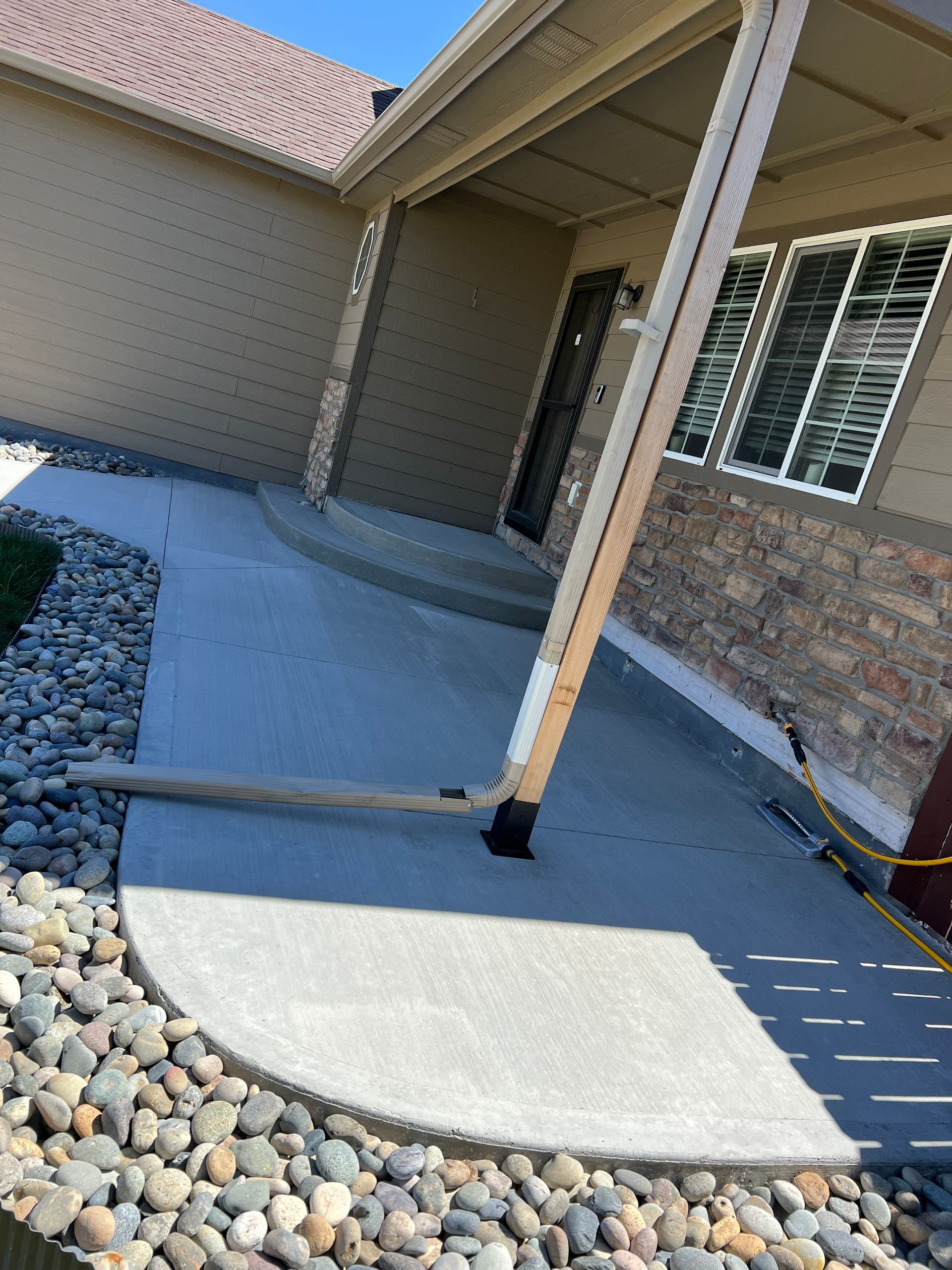 A concrete walkway leading to the front door of a house