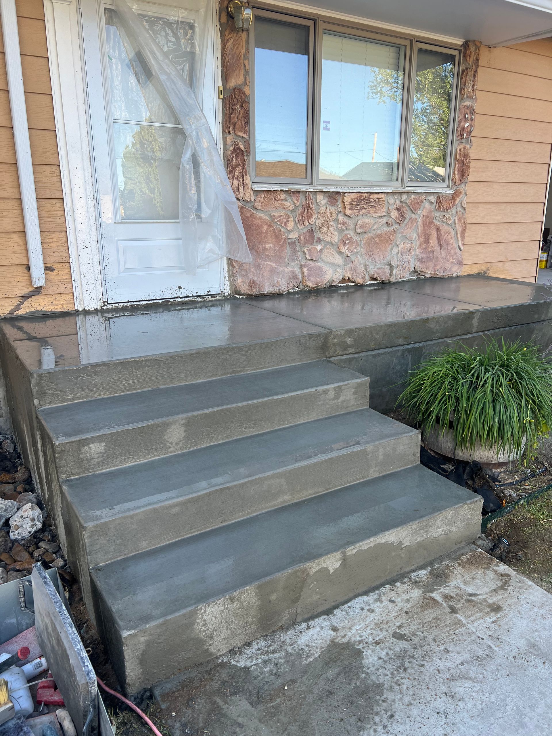 A set of concrete steps leading up to a house.