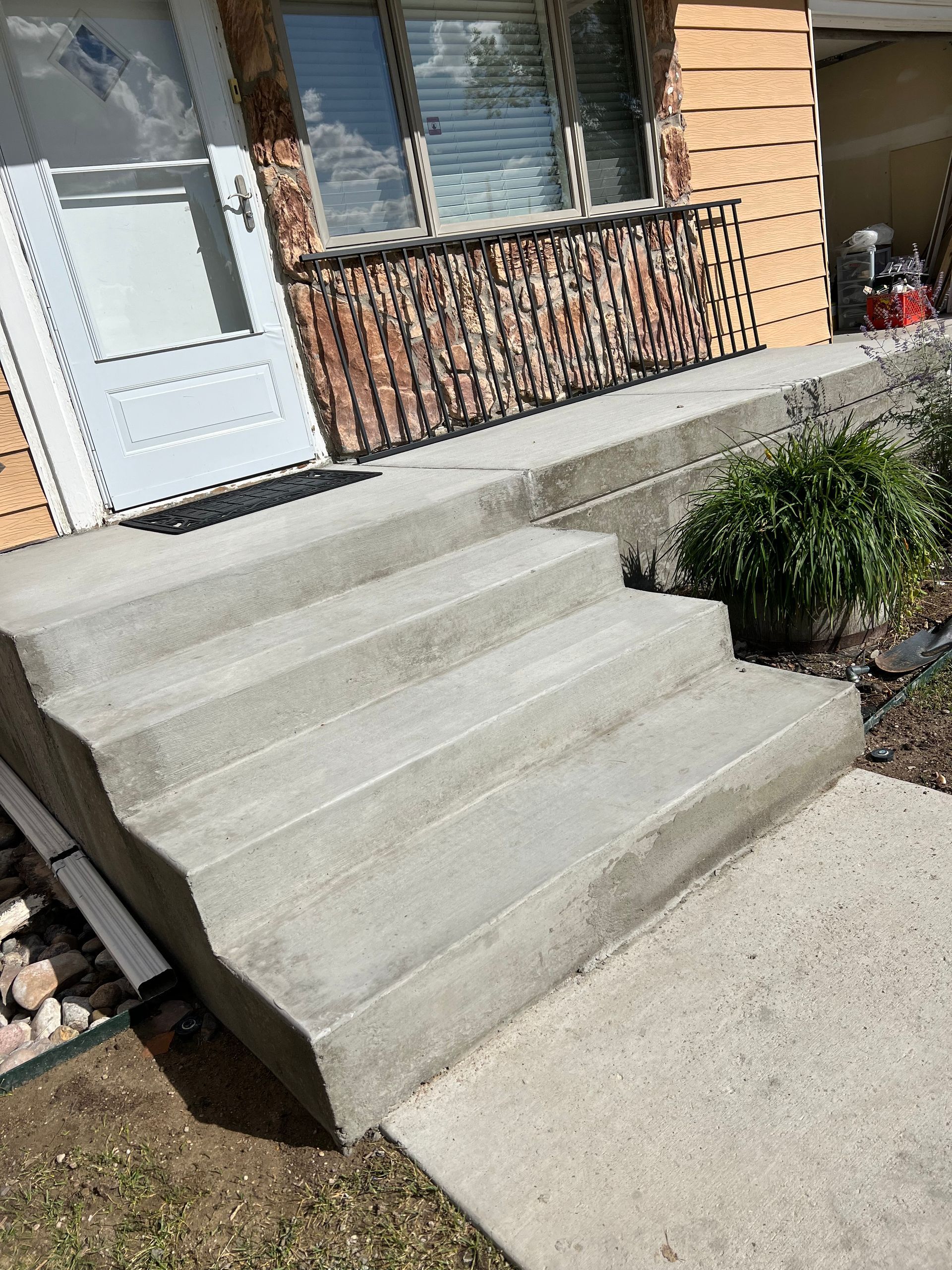 A set of concrete steps leading up to a house.