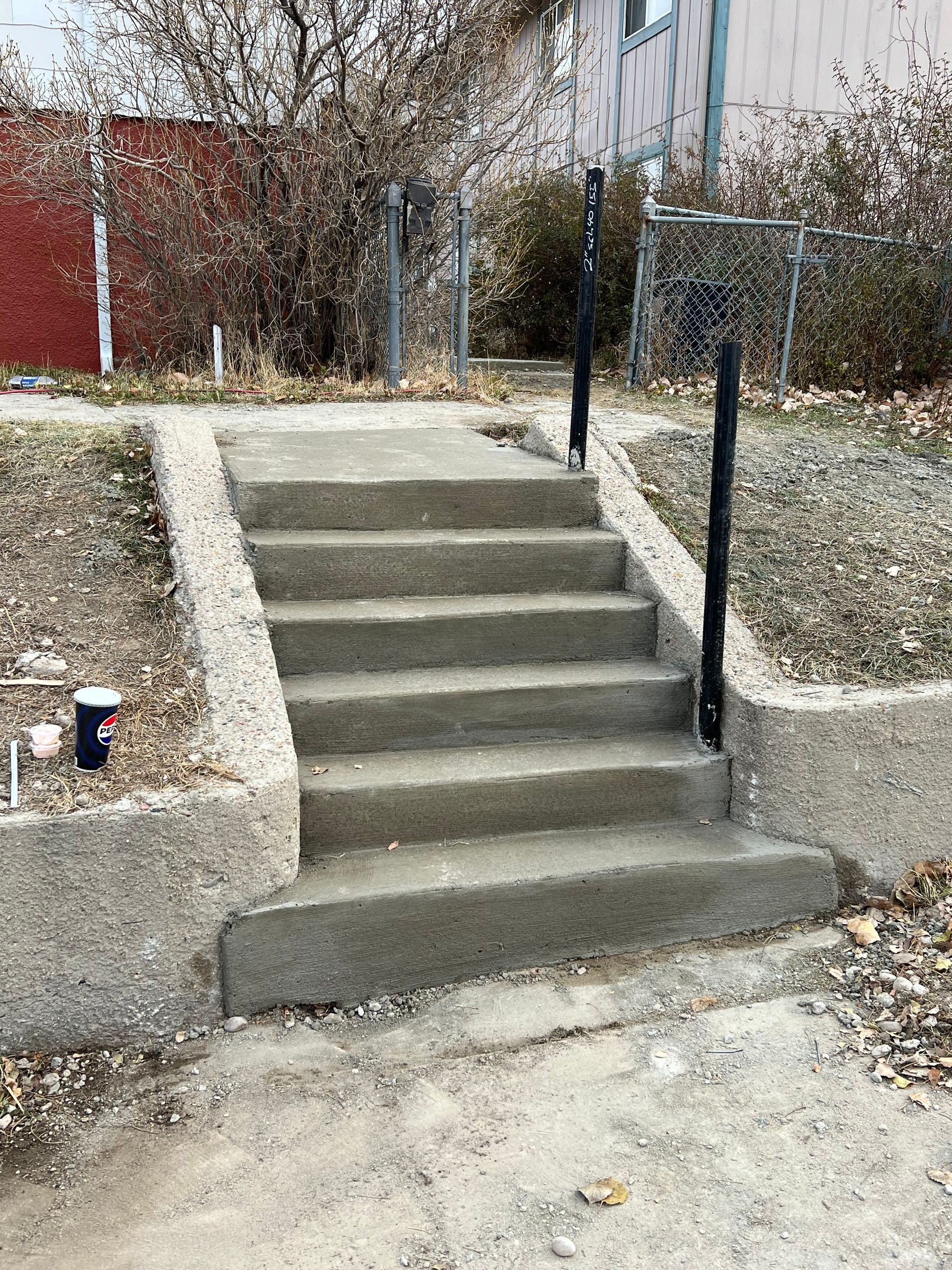 A set of concrete stairs leading up to a house.