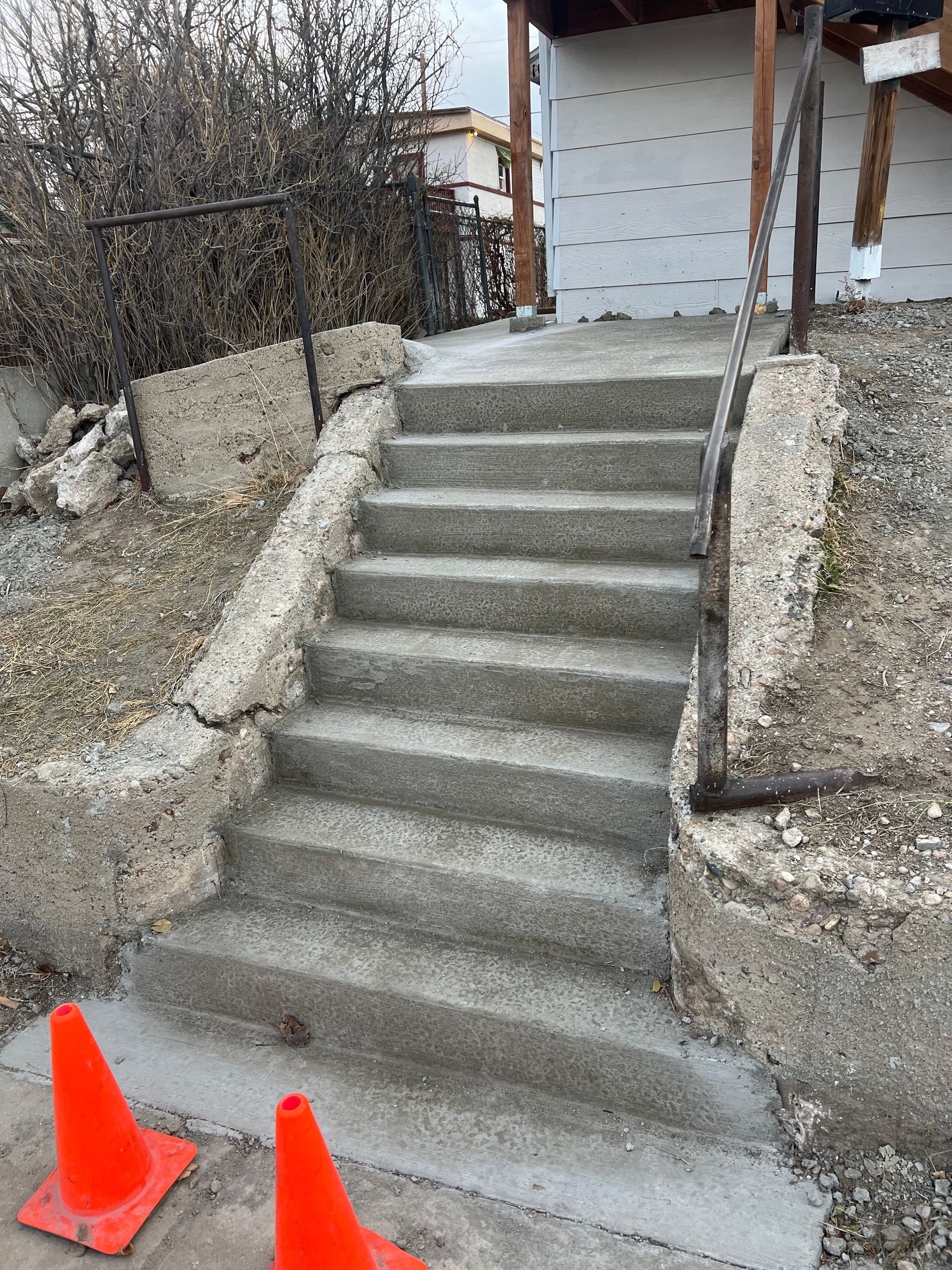 A set of concrete stairs leading up to a house.