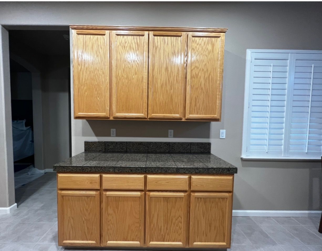 a kitchen with wooden cabinets and a granite counter top