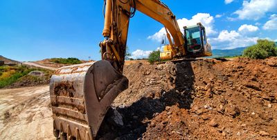 Construction Companies — An Excavator Digging Soil in San Antonio, TX