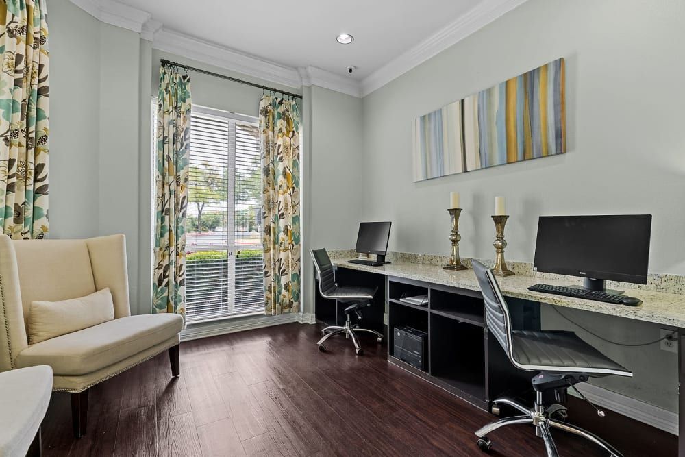 a room with two desks and two chairs with computers on them at Marquis at Ladera Vista in Austin, TX.