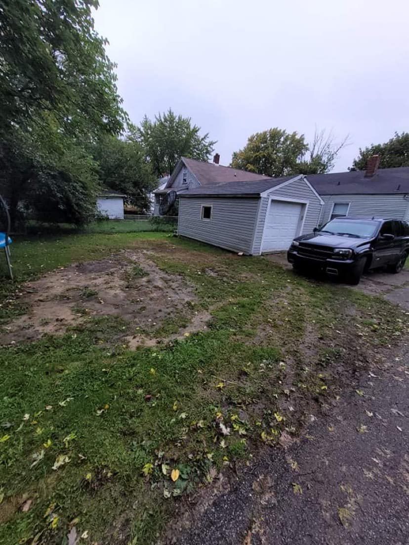 A black truck is parked in front of a house.