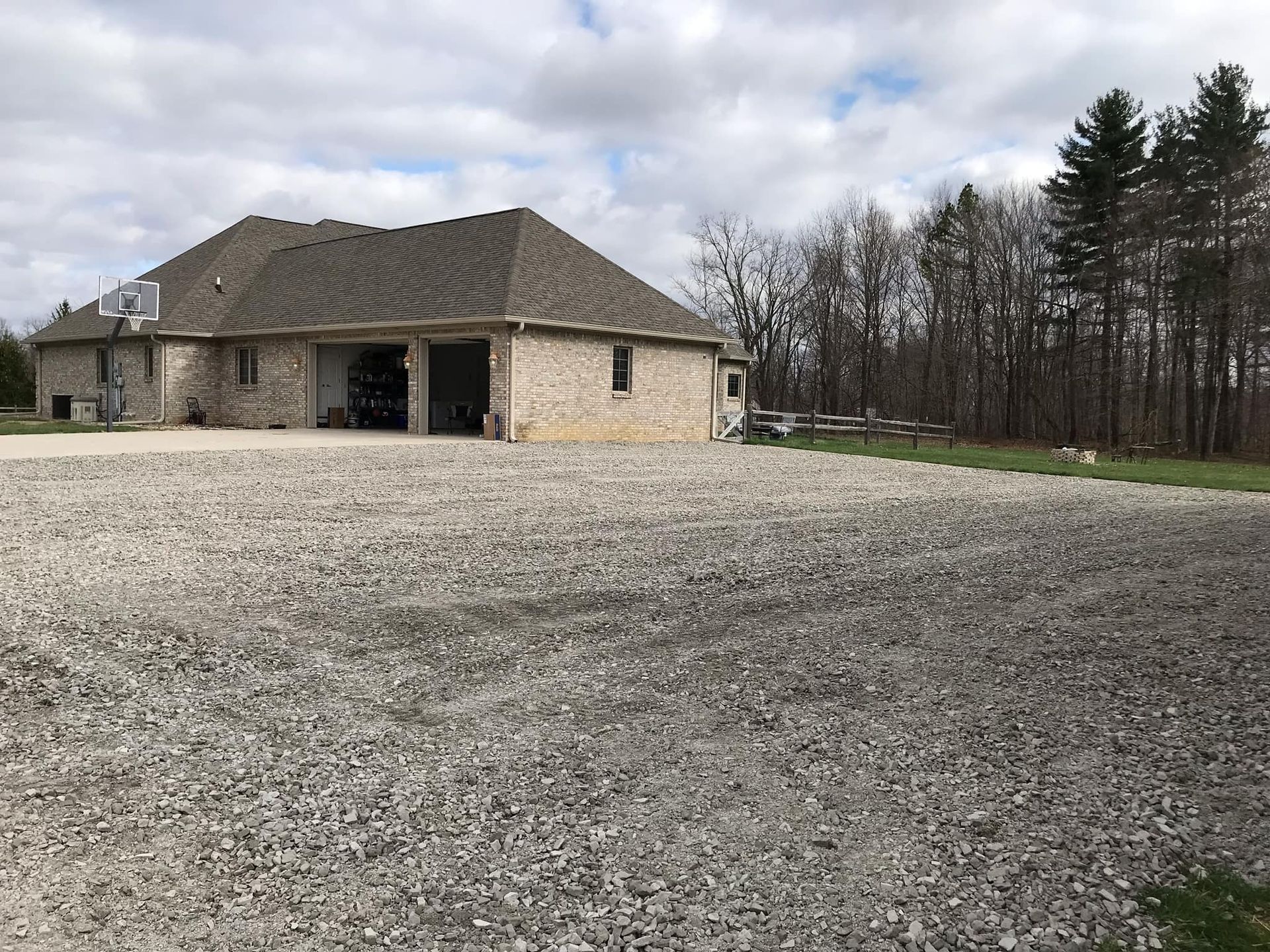 A house with a gravel driveway in front of it