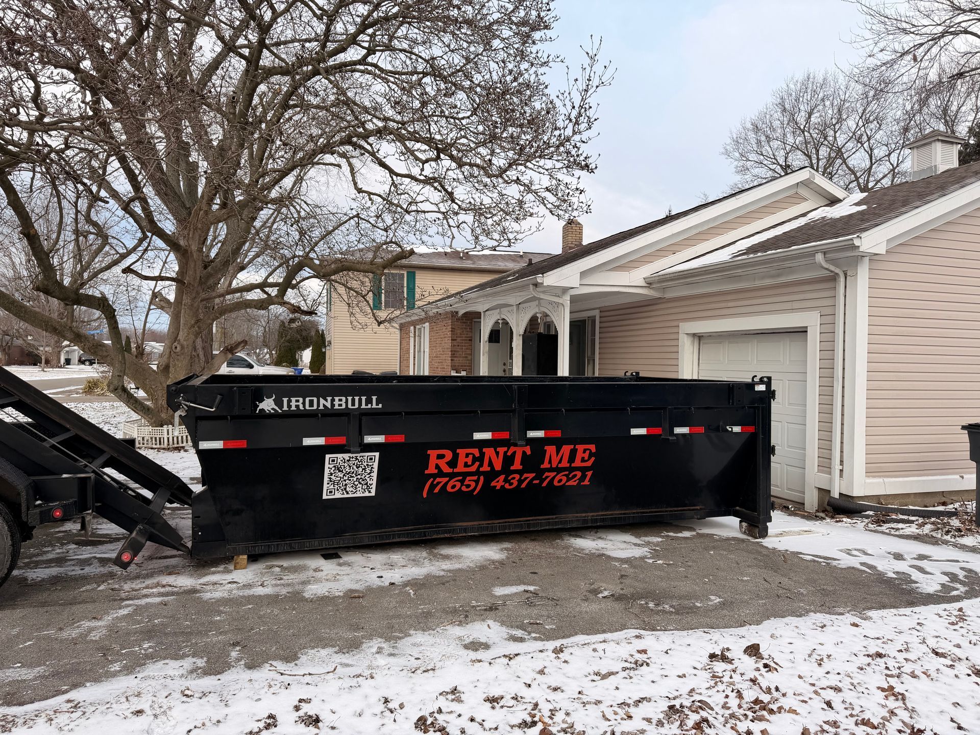 A large black Ironbull dumpster labeled 