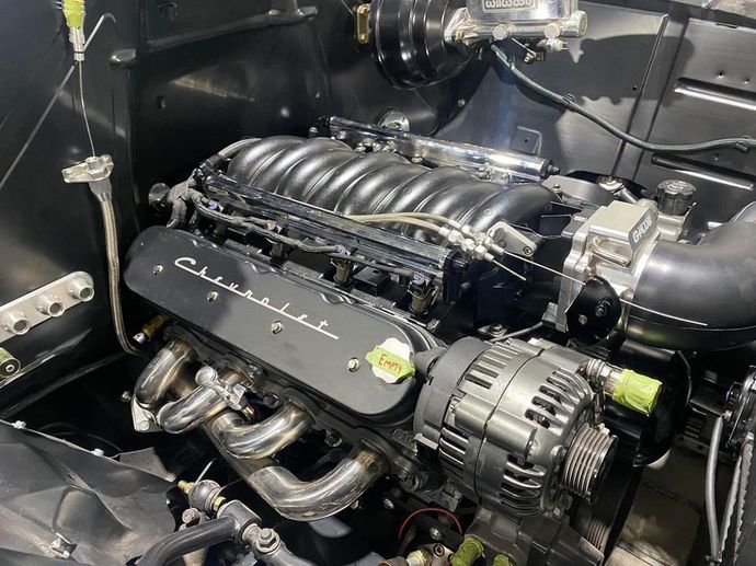 A close up of a black engine in a car.