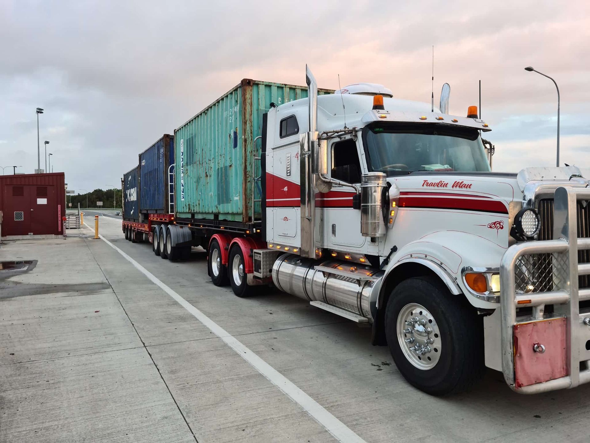 A semi truck is pulling a trailer with containers on it. — Equiptranz In Kybong, QLD
