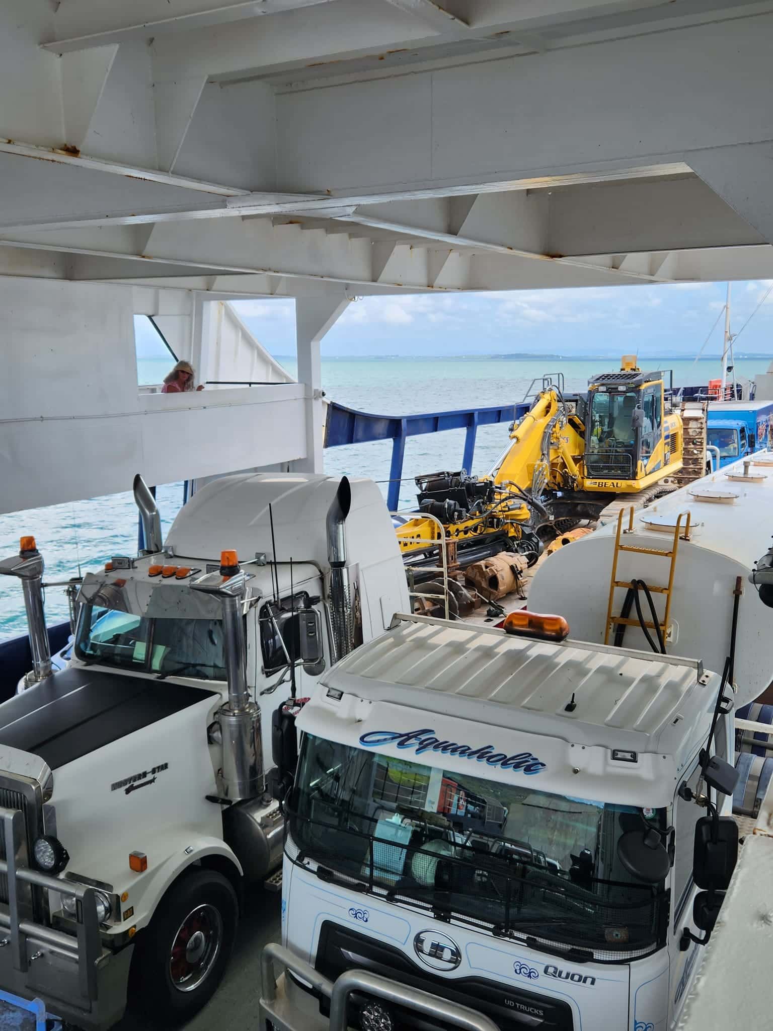 A Group Of Trucks Are Parked On The Deck Of A Boat — Equiptranz In Kybong, QLD