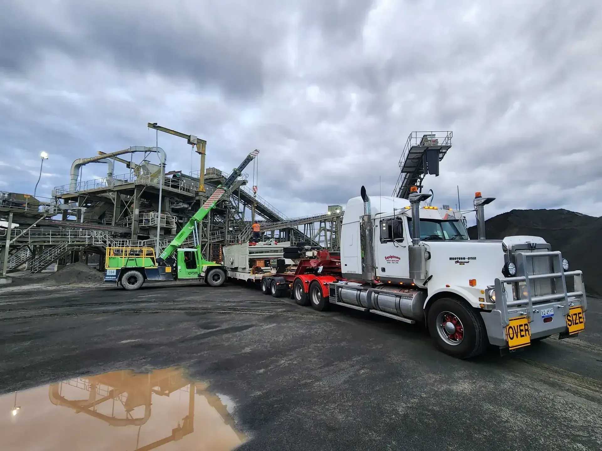 A white semi truck is parked in front of a construction site. — Equiptranz In Kybong, QLD