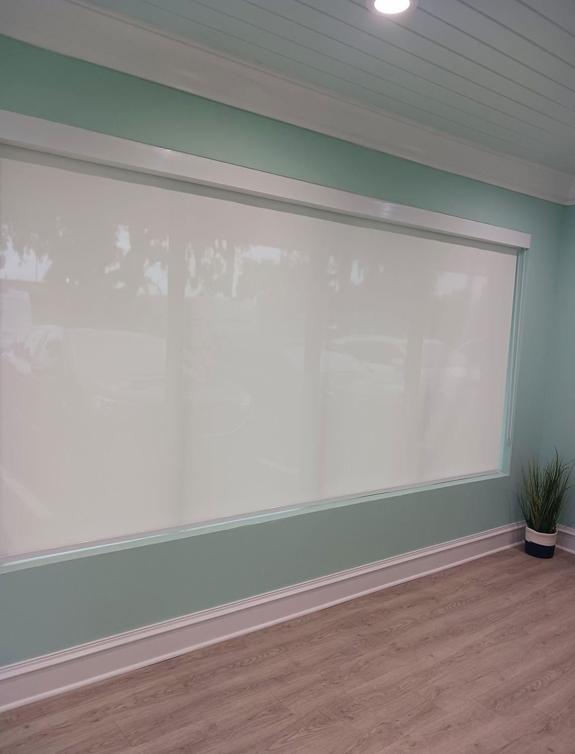 Room with large window and roller shades