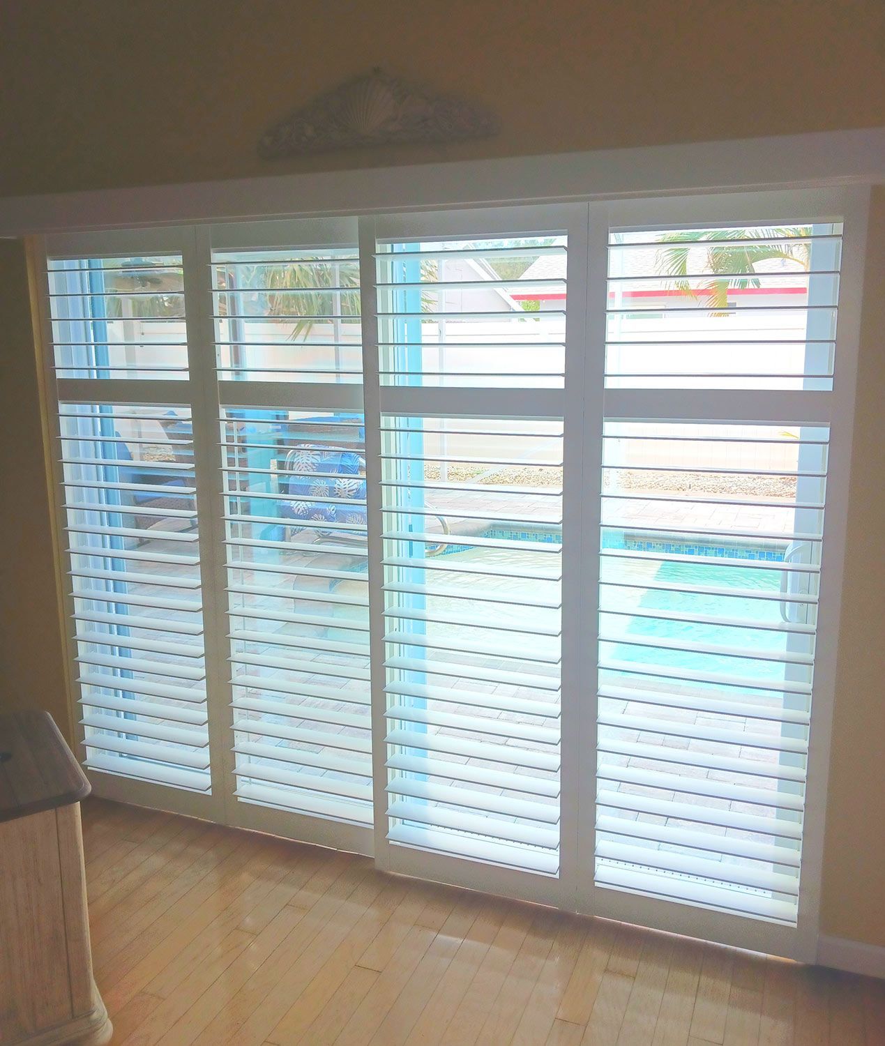 White louvered shutters installed in a room