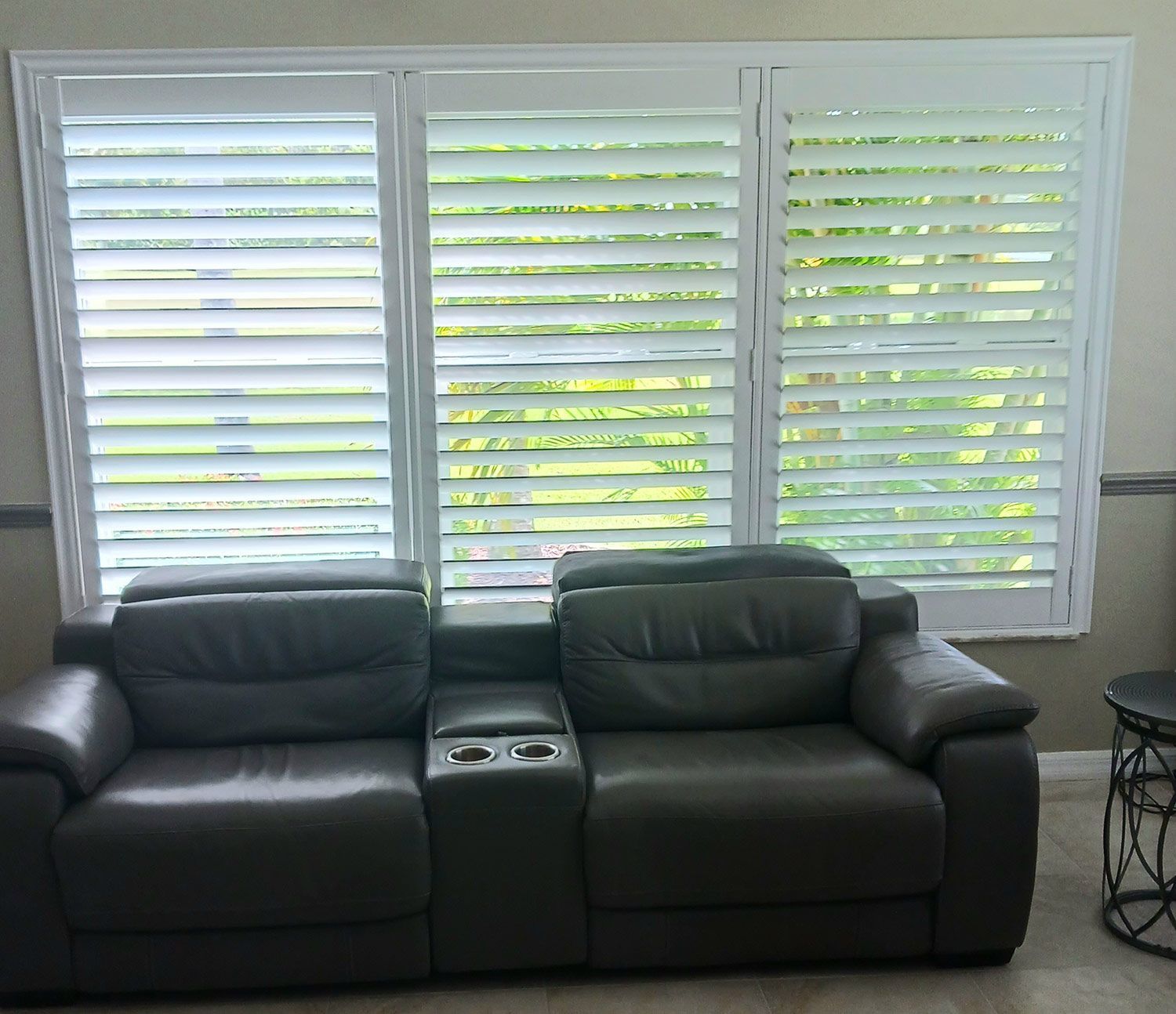 Living room with shutters and leather sofa