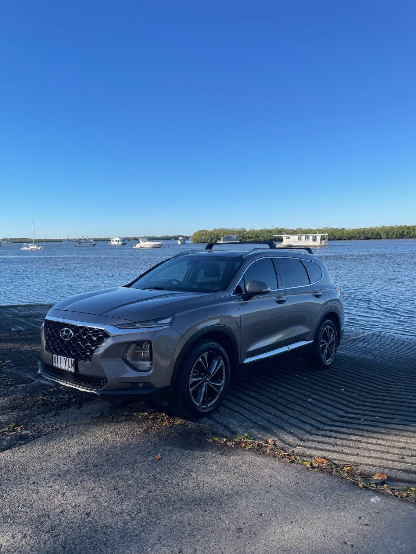 A Hyundai Santa Fe is Parked Next to a Body of Water — Pelican Motors Service Centre In Caloundra West, QLD 
