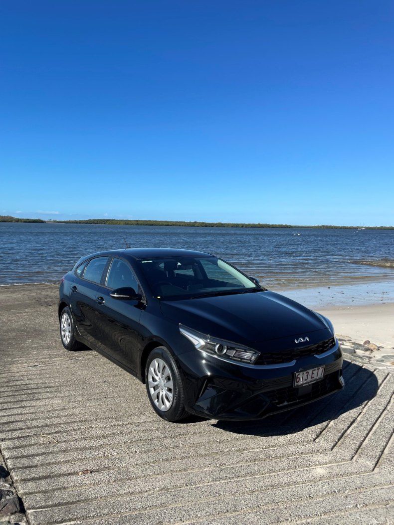 A Black Car is Parked on the Beach Next to a Body of Water — Pelican Motors Service Centre In Caloundra West, QLD 