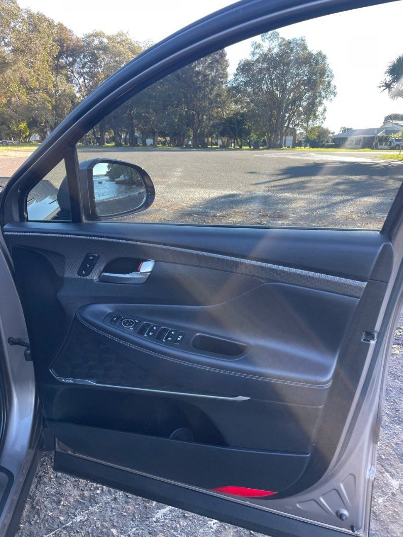 The Door of a Car is Open and There is a Park in the Background — Pelican Motors Service Centre In Caloundra West, QLD 