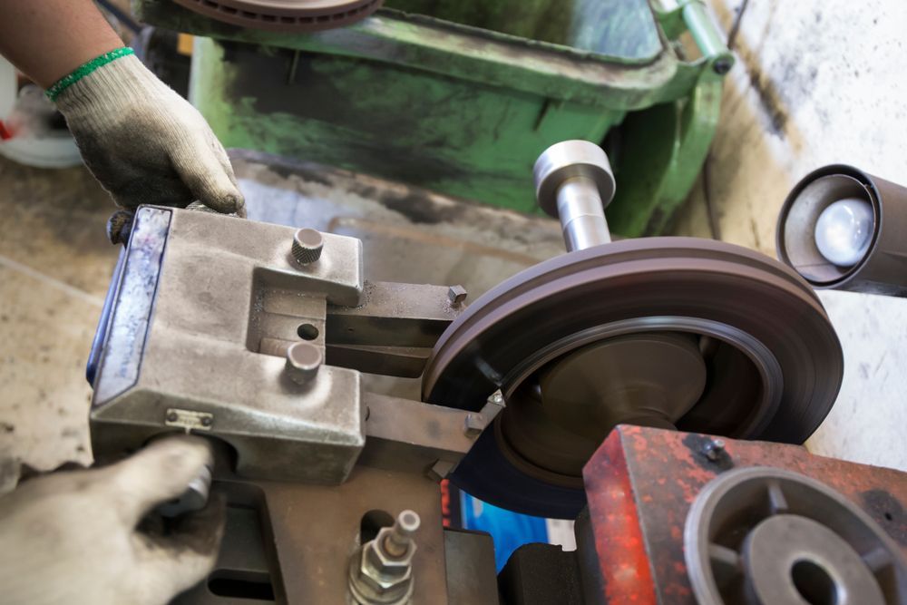 Mechanic Using a Brake Lathe to Resurface a Brake Rotor — Pelican Motors Service Centre in Caloundra West, QLD