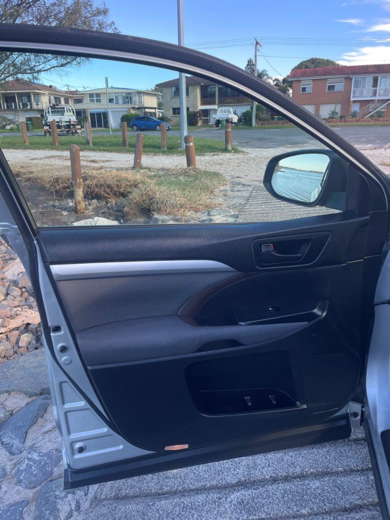 A Car is Parked on the Side of the Road With the Door Open — Pelican Motors Service Centre In Caloundra West, QLD 