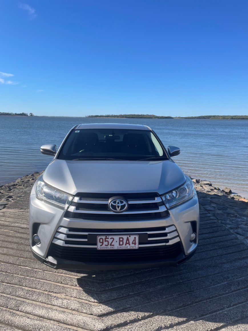 A Silver Toyota Highlander is Parked Next to a Body of Water — Pelican Motors Service Centre In Caloundra West, QLD 
