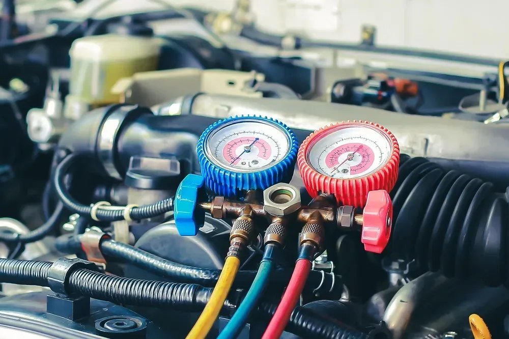 AC gauges connected to a car engine, indicating pressure levels. — Pelican Motors Service Centre in Caloundra West, QLD