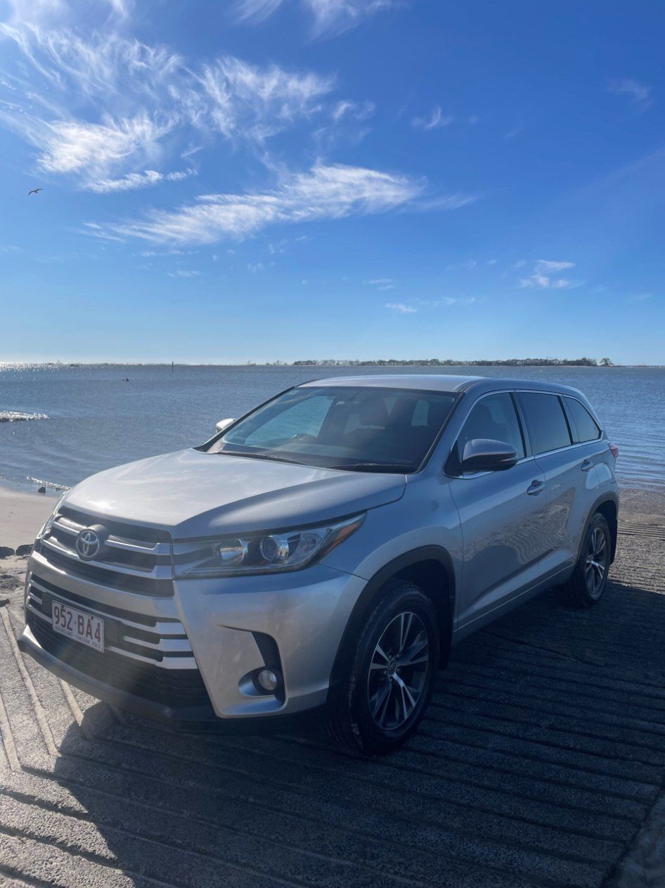 A Silver Toyota Highlander is Parked Next to a Body of Water — Pelican Motors Service Centre In Caloundra West, QLD 