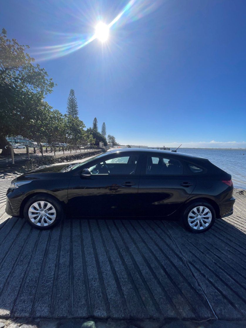 A Black Car is Parked on a Dock Next to a Body of Water — Pelican Motors Service Centre In Caloundra West, QLD 