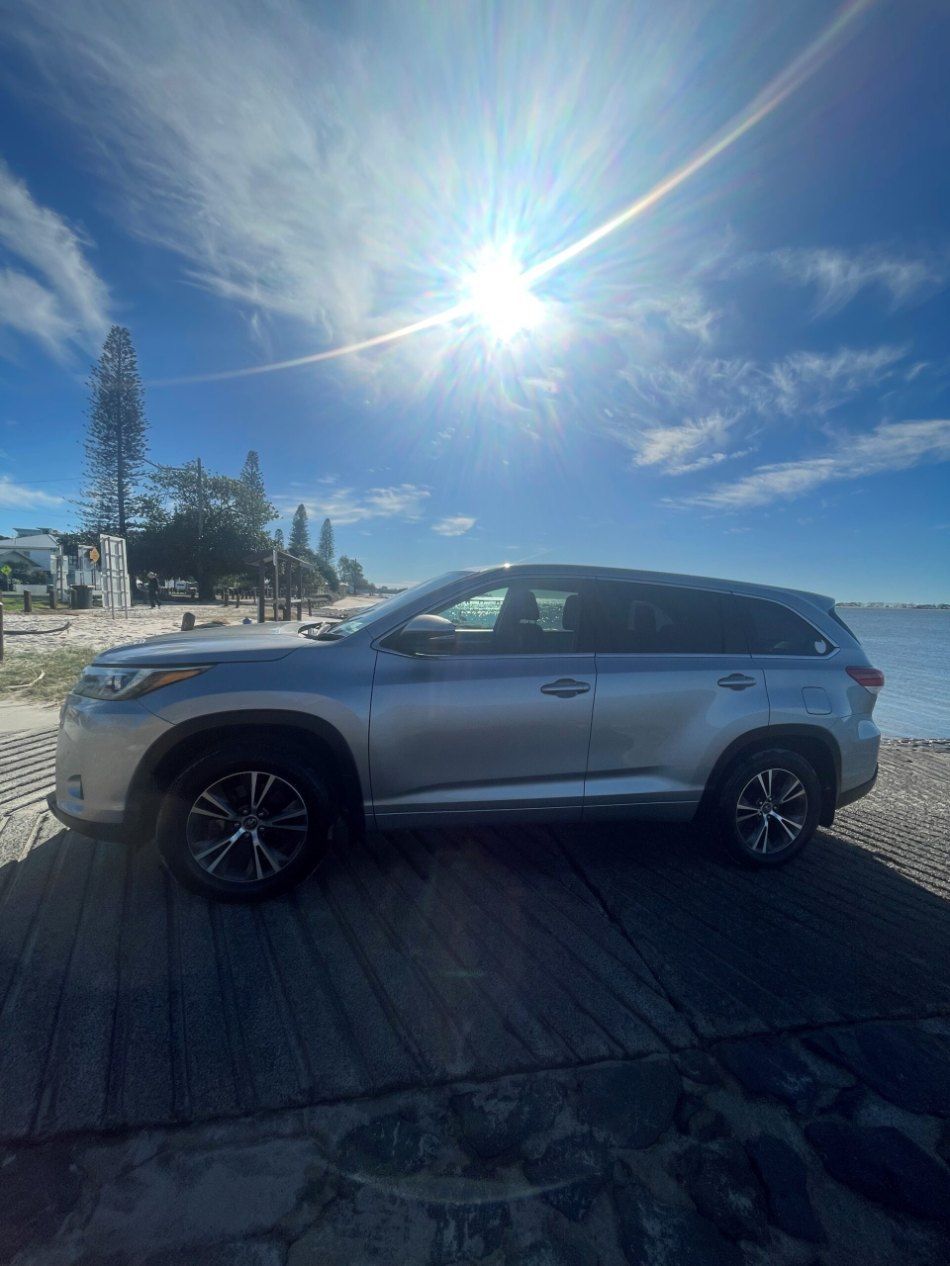 A Silver Car is Parked on the Side of the Road Next to a Body of Water — Pelican Motors Service Centre In Caloundra West, QLD 
