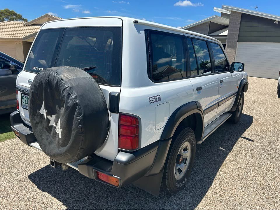A White Suv With a Spare Tire is Parked in a Driveway — Pelican Motors Service Centre In Caloundra West, QLD 