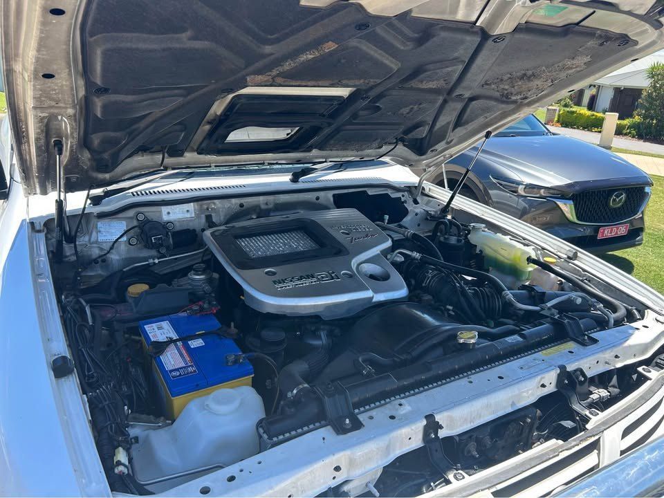 The Hood of a White Car is Open and the Engine is Visible — Pelican Motors Service Centre In Caloundra West, QLD 