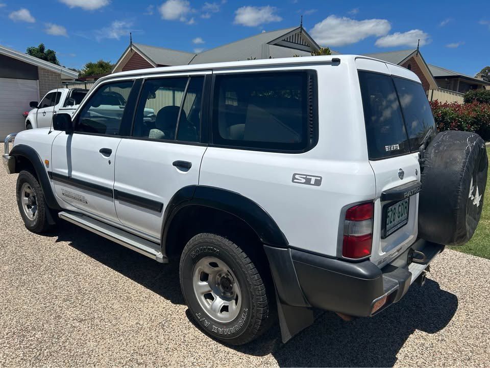 A White Suv is Parked in a Driveway in Front of a House — Pelican Motors Service Centre In Caloundra West, QLD 