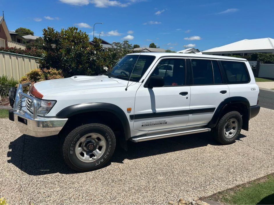 A White Suv is Parked on a Gravel Driveway in Front of a House — Pelican Motors Service Centre In Caloundra West, QLD 