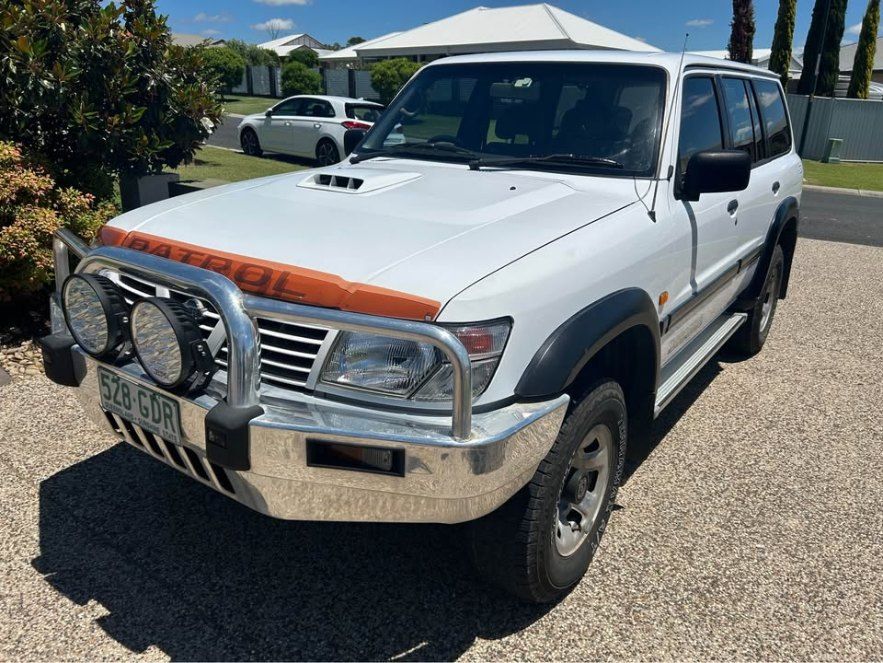 A White Suv is Parked on a Gravel Driveway in Front of a House — Pelican Motors Service Centre In Caloundra West, QLD 