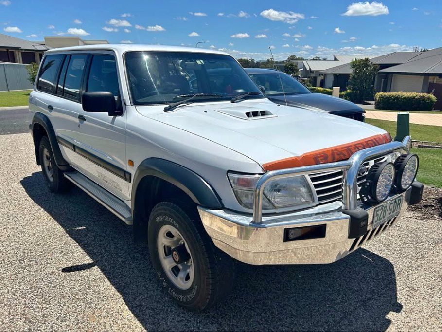 A White Suv is Parked in a Driveway in Front of a House — Pelican Motors Service Centre In Caloundra West, QLD 