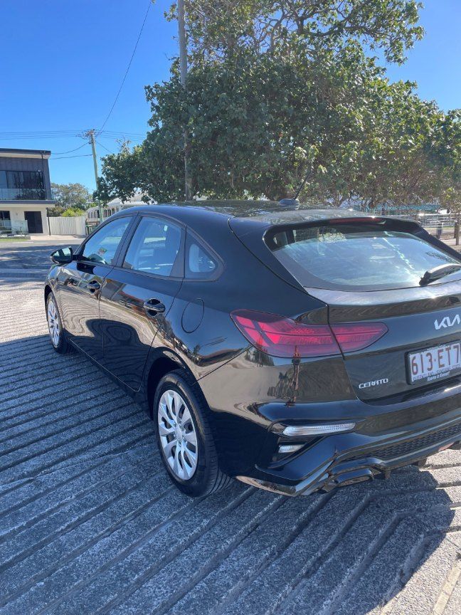 A Black Car is Parked in a Parking Lot Next to a Tree — Pelican Motors Service Centre In Caloundra West, QLD 