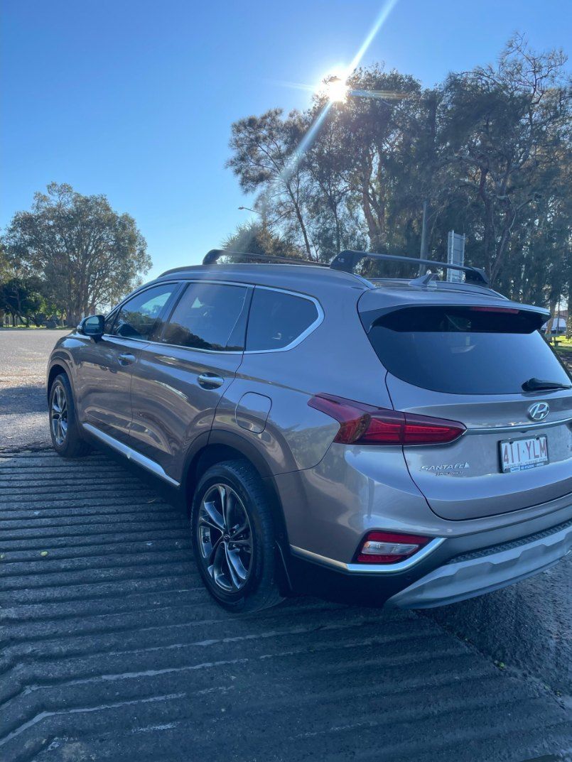 A Gray Suv is Parked on a Wooden Dock on a Sunny Day — Pelican Motors Service Centre In Caloundra West, QLD 