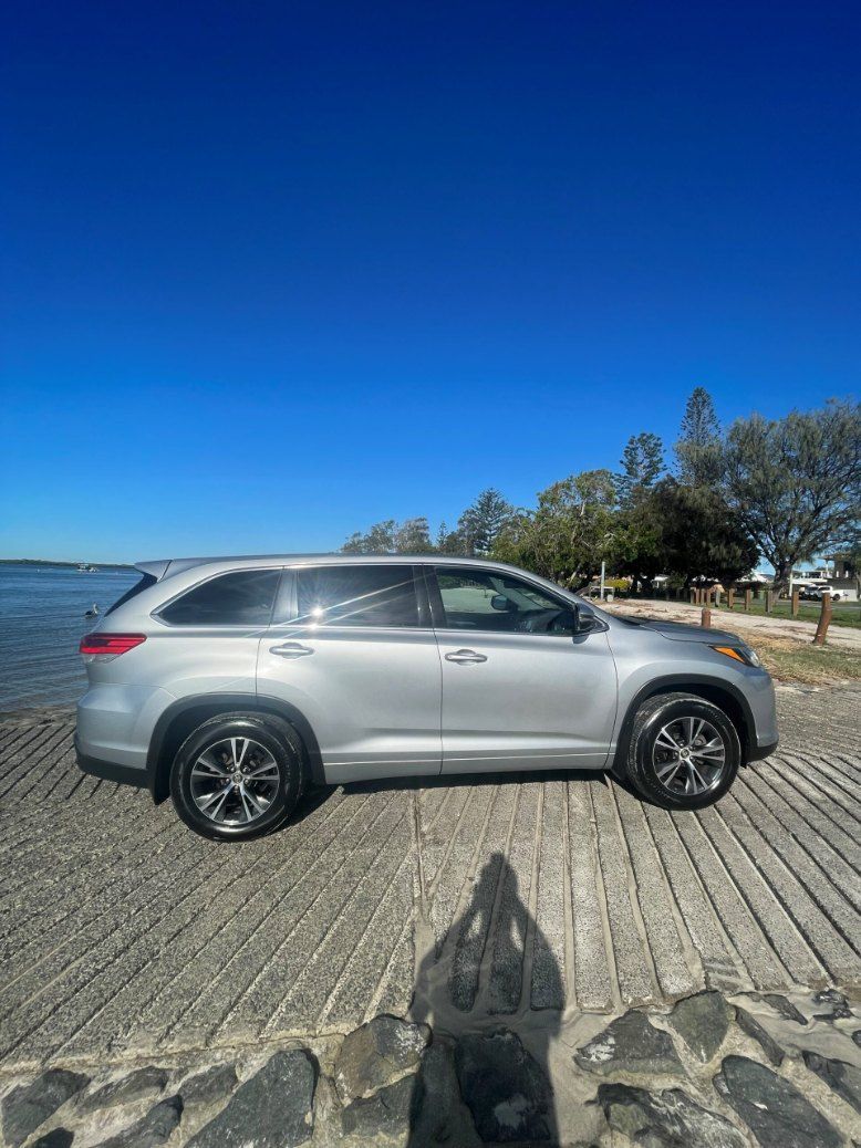 A Silver Car is Parked on the Beach Next to a Body of Water — Pelican Motors Service Centre In Caloundra West, QLD 