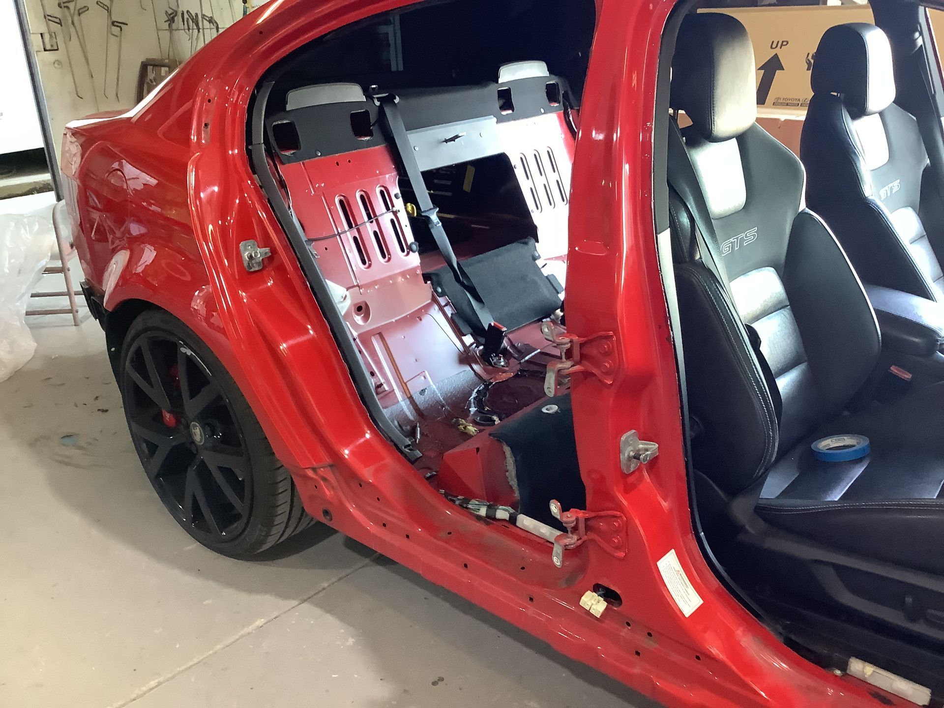 A Car is Sitting on a Lift in a Garage — Pelican Motors Service Centre In Caloundra West, QLD