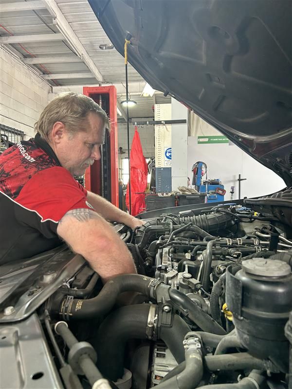 A Person is Fixing a Brake Pad on a Car — Pelican Motors Service Centre In Caloundra West, QLD