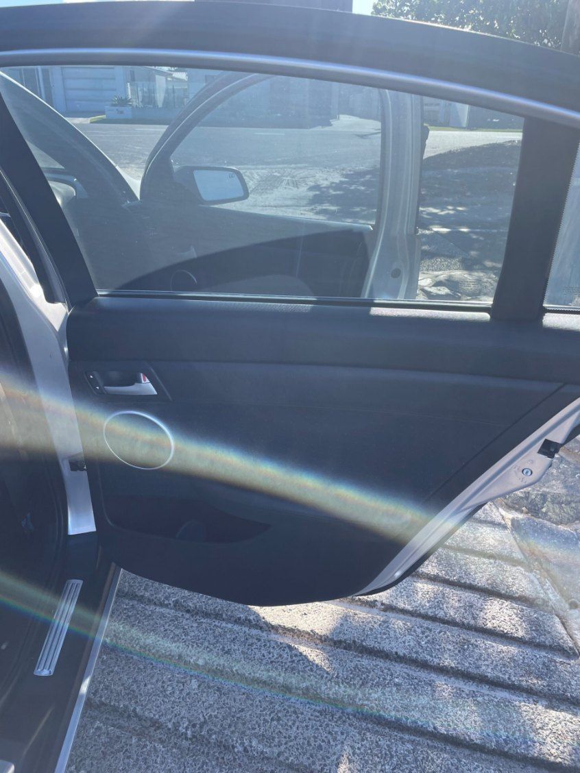 A Car With the Door Open is Parked on the Side of the Road — Pelican Motors Service Centre In Caloundra West, QLD 